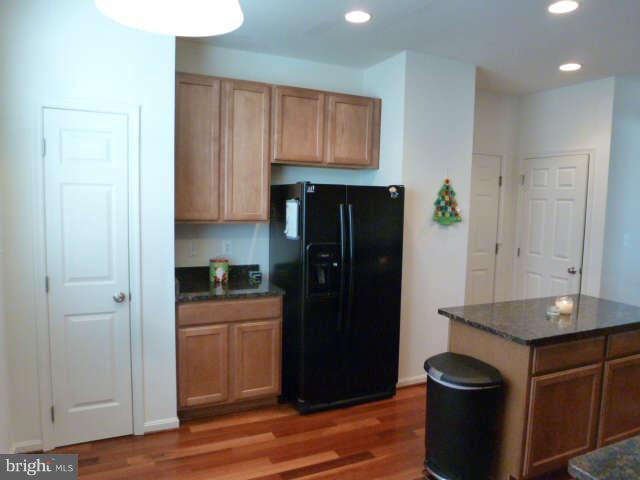 81 Glenbrook Road Ranson, WV 25438 - Photo 12 of 30 a kitchen with granite countertop stainless steel appliances and wooden cabinets