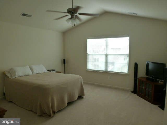 81 Glenbrook Road Ranson, WV 25438 - Photo 17 of 30 a bedroom with a bed and a flat tv screen on the dresser