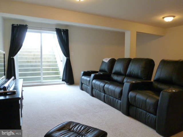 81 Glenbrook Road Ranson, WV 25438 - Photo 23 of 30 a blue couch sitting in a living room next to a window