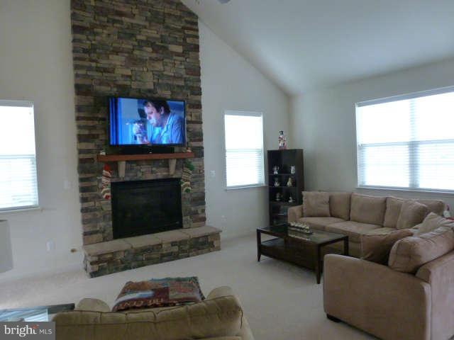 81 Glenbrook Road Ranson, WV 25438 - Photo 6 of 30 a living room with furniture a flat screen tv and a fireplace
