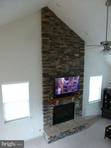 81 Glenbrook Road Ranson, WV 25438 - Photo 7 of 30 a living room with a fireplace and a flat screen tv
