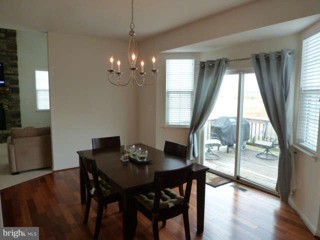 81 Glenbrook Road Ranson, WV 25438 - Photo 8 of 30 a view of a dining room with furniture window and wooden floor