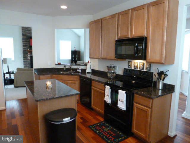 81 Glenbrook Road Ranson, WV 25438 - Photo 10 of 30 a kitchen with stainless steel appliances granite countertop a stove a sink and a microwave