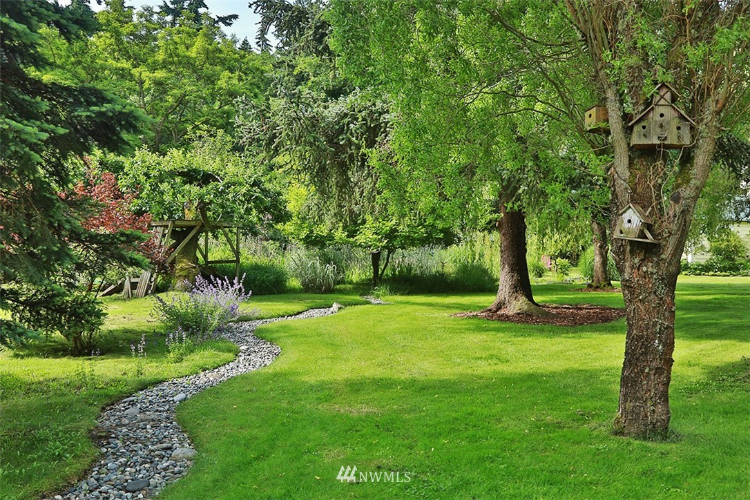 1618 & 1616 Lancaster Road Freeland, WA 98249 - Photo 26 of 40 a view of a backyard with large trees