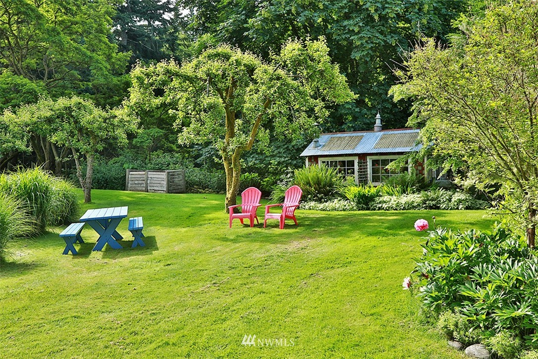 1618 & 1616 Lancaster Road Freeland, WA 98249 - Photo 28 of 40 a view of a house with a yard porch and sitting area