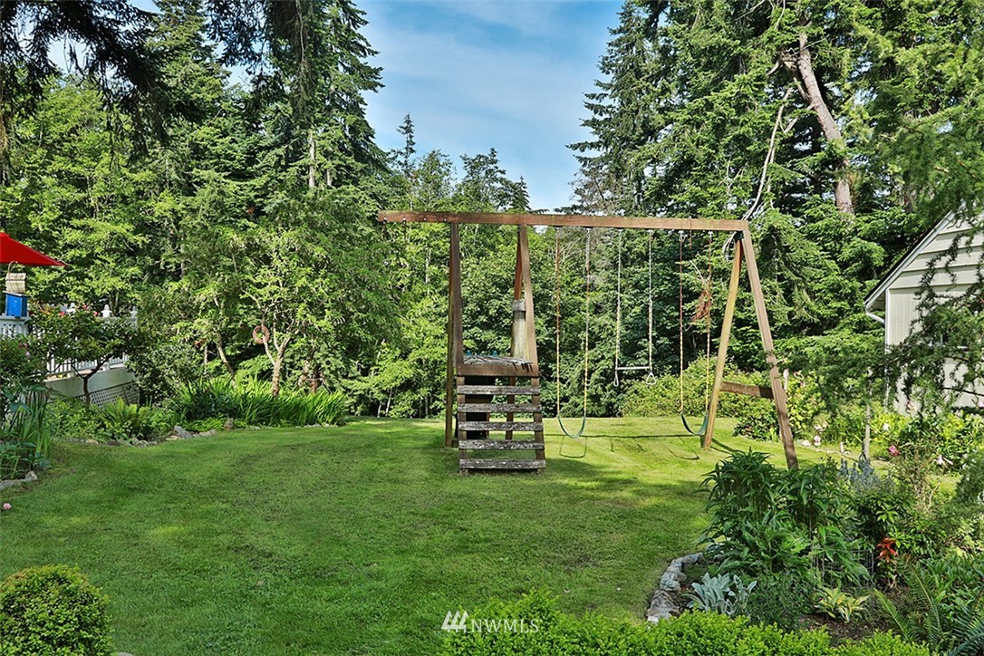1618 & 1616 Lancaster Road Freeland, WA 98249 - Photo 34 of 40 a view of a bench in a grassy field