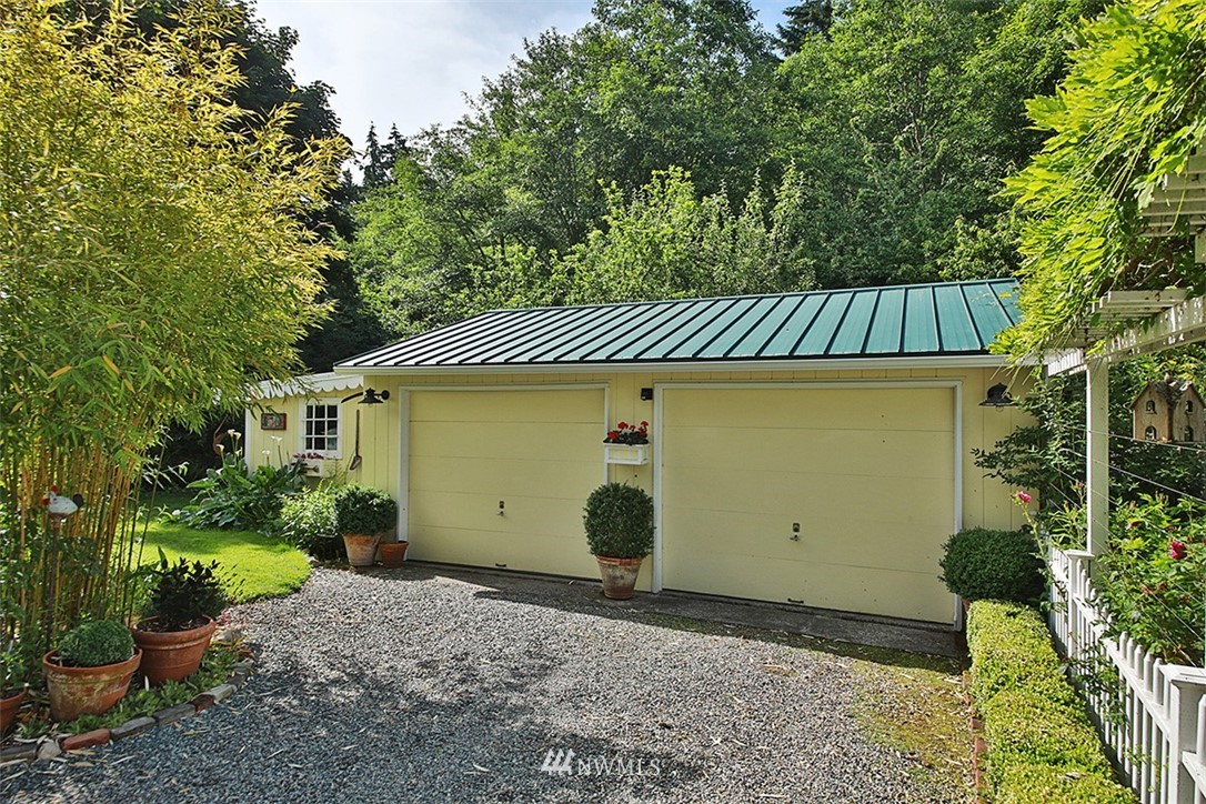 1618 & 1616 Lancaster Road Freeland, WA 98249 - Photo 35 of 40 a view of a house with a yard and plants