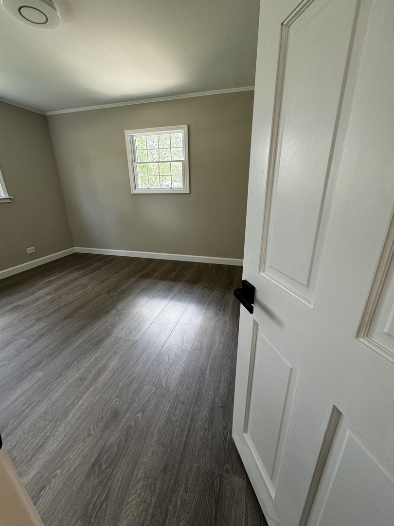 3302 St James Street Rolling Meadows, IL 60008 - Photo 15 of 20 an empty room with wooden floor and windows