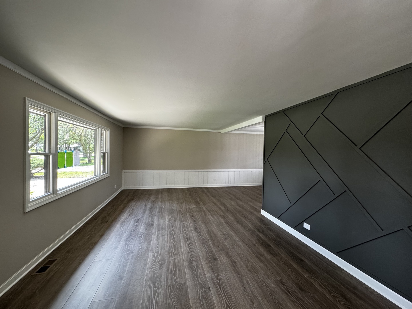 3302 St James Street Rolling Meadows, IL 60008 - Photo 4 of 20 a view of an empty room with wooden floor and a window