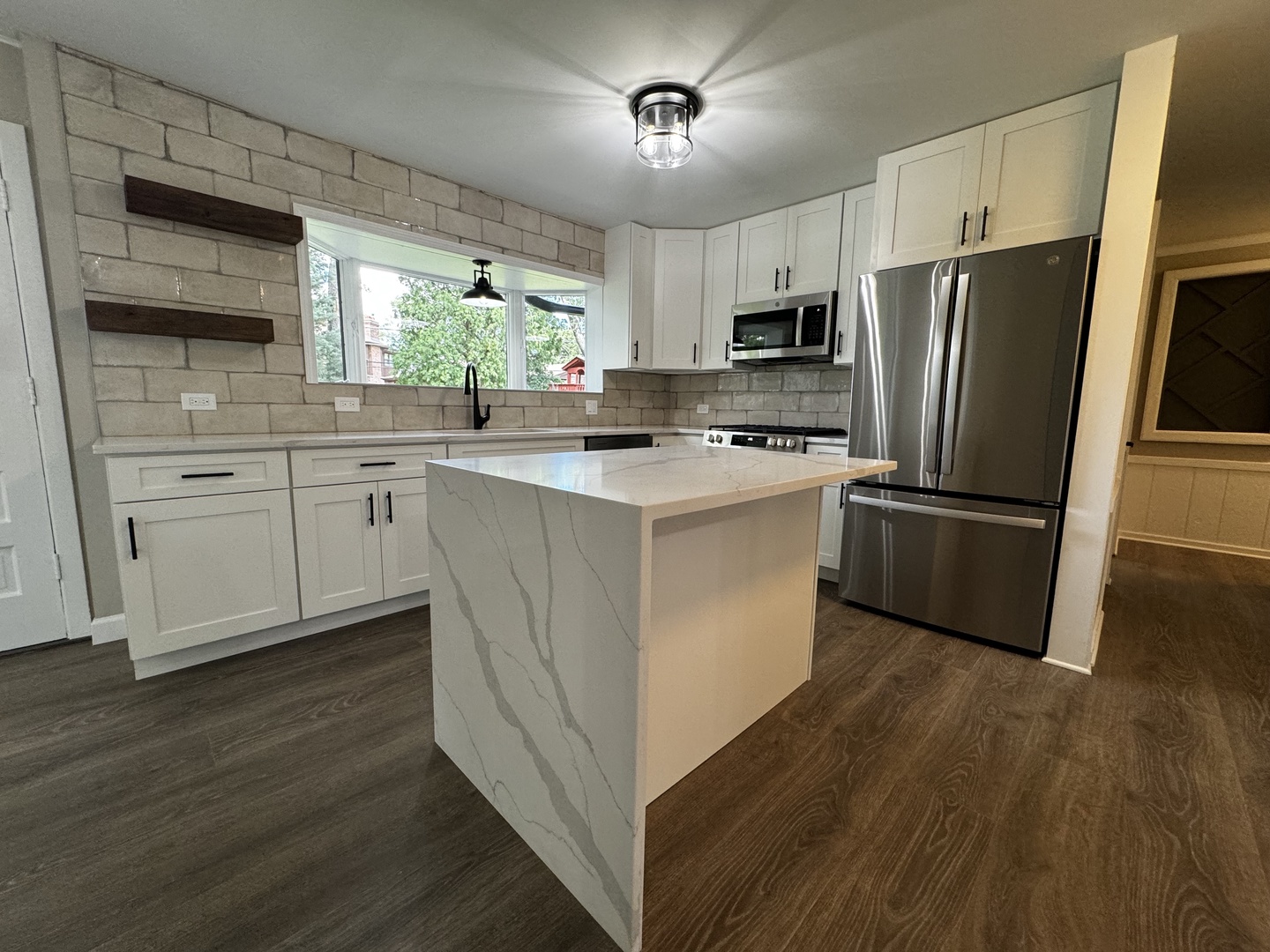 3302 St James Street Rolling Meadows, IL 60008 - Photo 5 of 20 a kitchen with cabinets stainless steel appliances a sink and a window