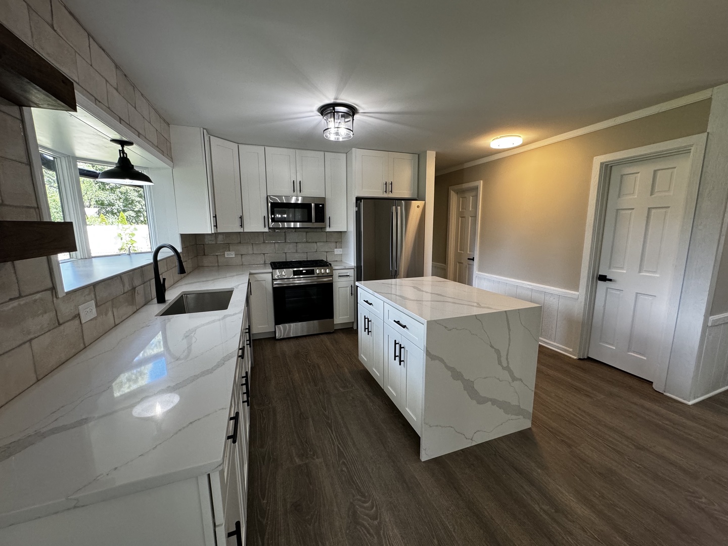 3302 St James Street Rolling Meadows, IL 60008 - Photo 6 of 20 a kitchen with stainless steel appliances granite countertop a sink a stove a refrigerator cabinets and wooden floor