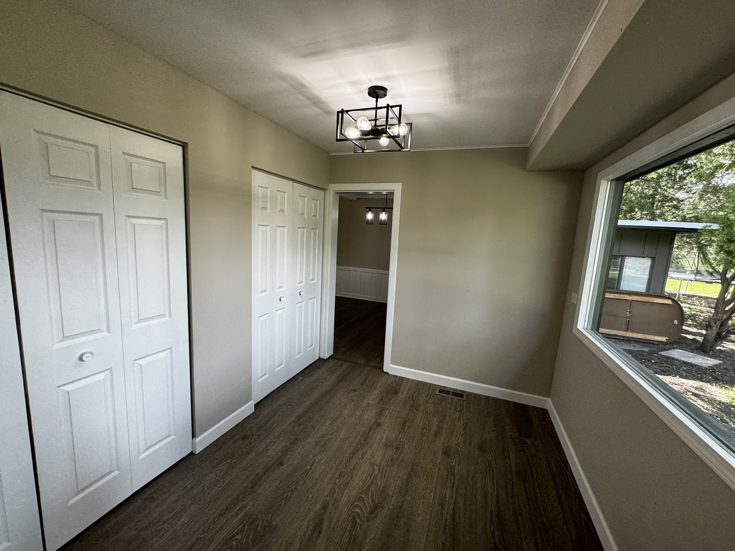 3302 St James Street Rolling Meadows, IL 60008 - Photo 7 of 20 an empty room with wooden floor cabinet and windows