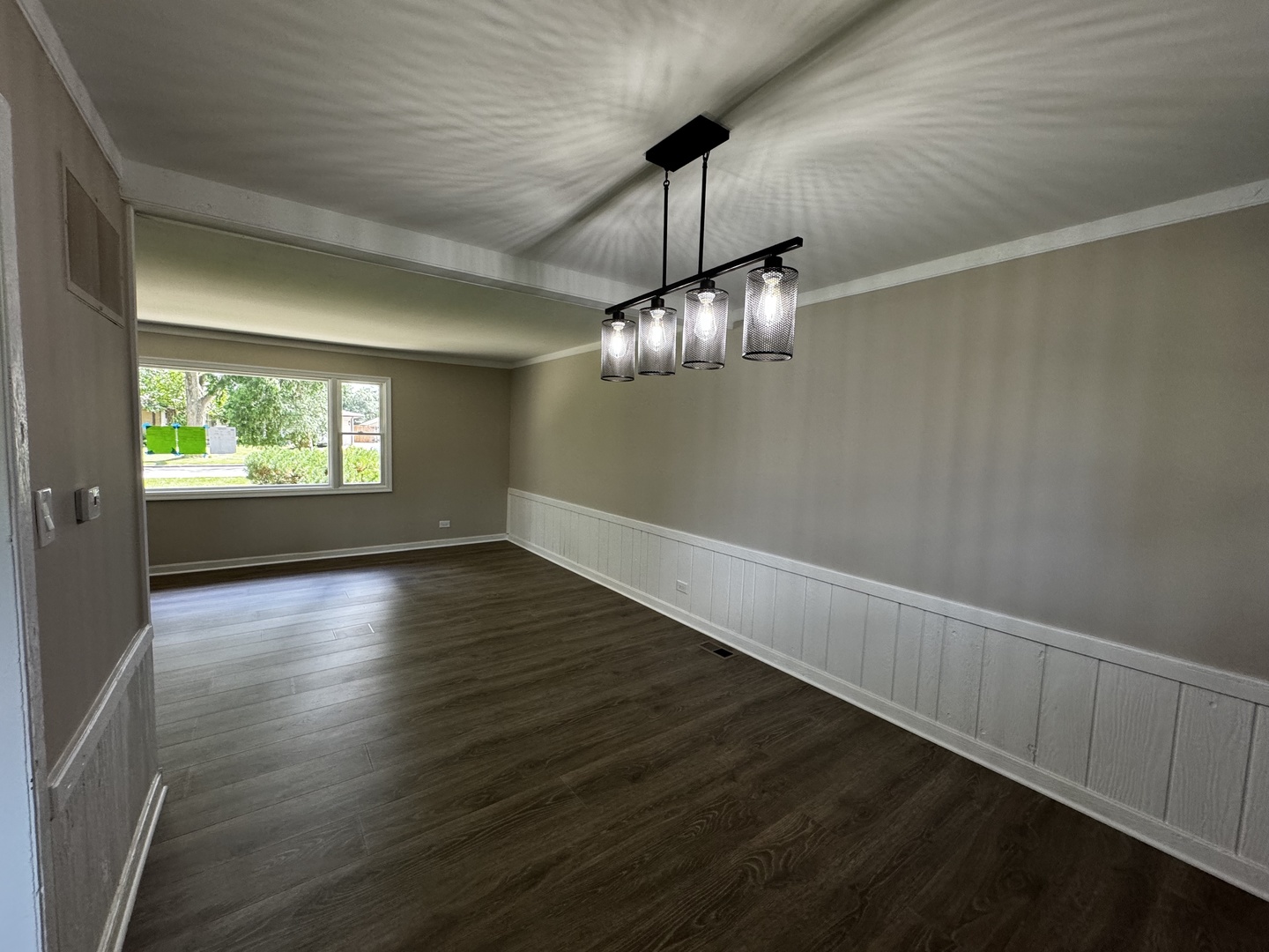 3302 St James Street Rolling Meadows, IL 60008 - Photo 8 of 20 a view of an empty room with wooden floor and a window
