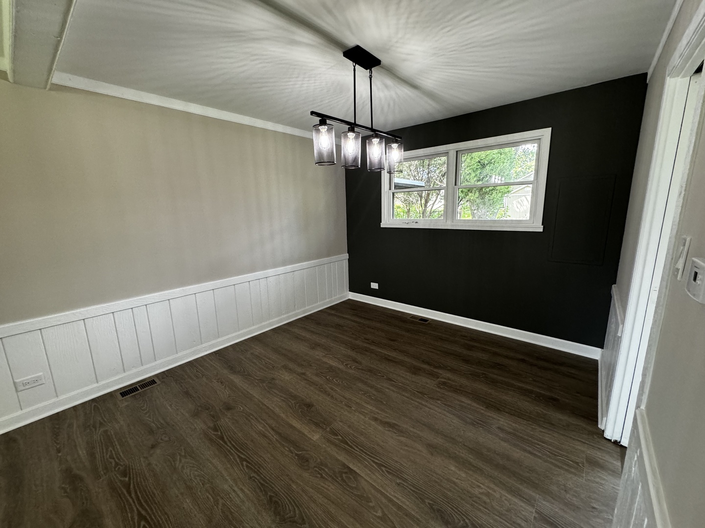 3302 St James Street Rolling Meadows, IL 60008 - Photo 9 of 20 a view of an empty room with wooden floor and a window