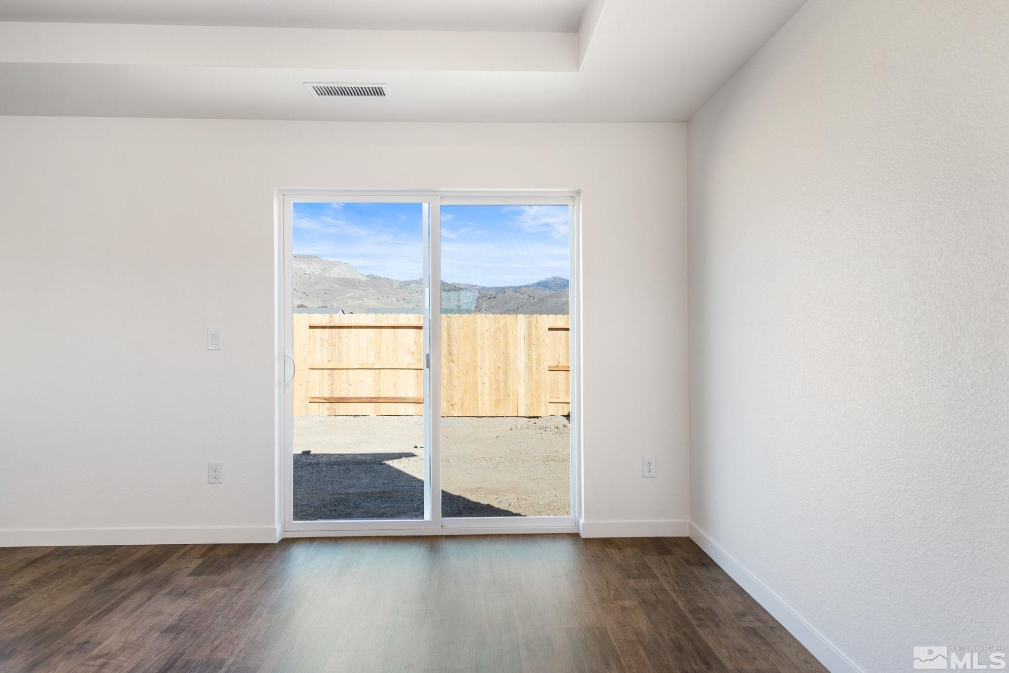 211 Green Lane Dayton, NV 89403 - Photo 12 of 28 a view of an empty room with wooden floor and a window