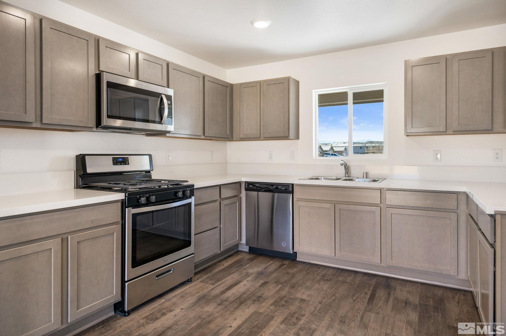 211 Green Lane Dayton, NV 89403 - Photo 14 of 28 a kitchen with granite countertop a sink cabinets and stainless steel appliances