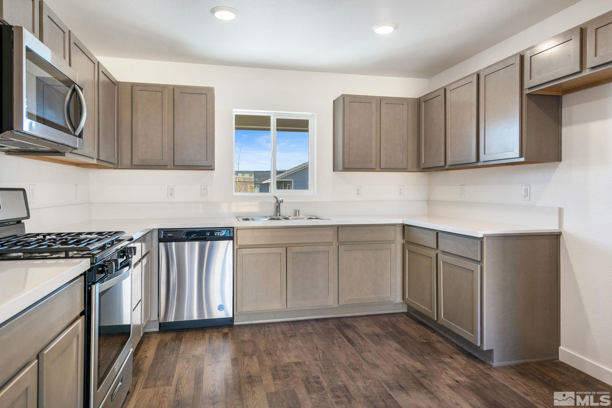 211 Green Lane Dayton, NV 89403 - Photo 15 of 28 a kitchen with a sink stove and cabinets