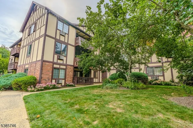 a front view of a residential apartment building with a yard