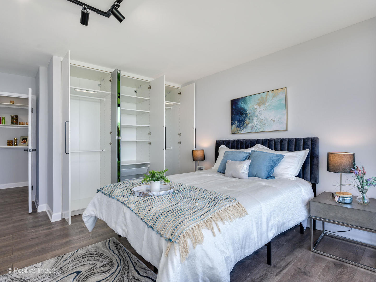 5445 North Sheridan Road, Unit 3404 Chicago, IL 60640 - Photo 17 of 24 a bedroom with bed and a chandelier