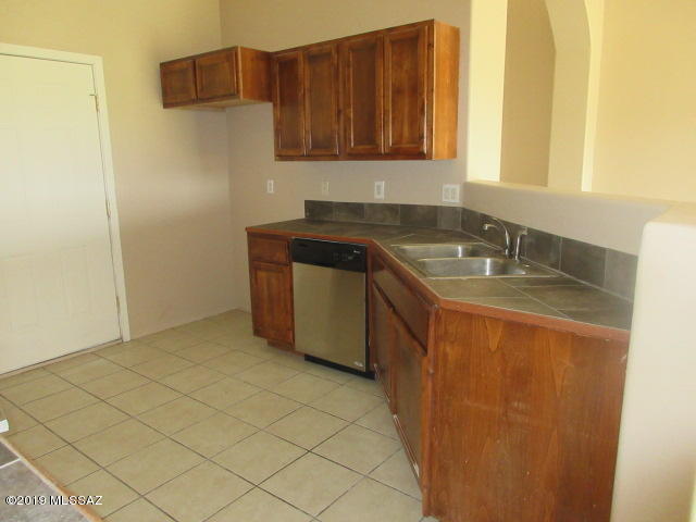 965 Circulo Tumbleweed Rio Rico, AZ 85648 - Photo 6 of 18 a kitchen with a sink and a refrigerator