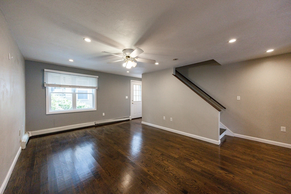 210 West Sixth Street, Unit 210 Boston, MA 02127 - Photo 21 of 36 a view of an empty room with wooden floor and a window
