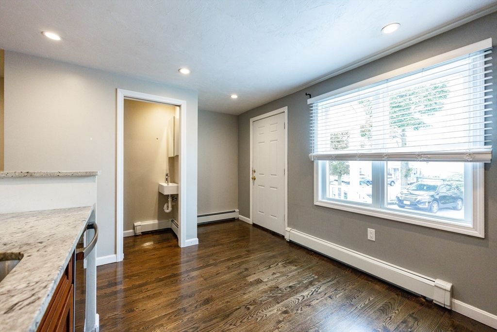 210 West Sixth Street, Unit 210 Boston, MA 02127 - Photo 22 of 36 an empty room with wooden floor and windows