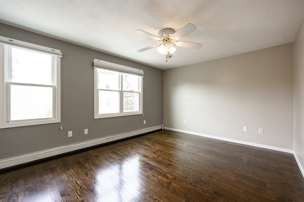 210 West Sixth Street, Unit 210 Boston, MA 02127 - Photo 28 of 36 a view of an empty room with wooden floor and a window