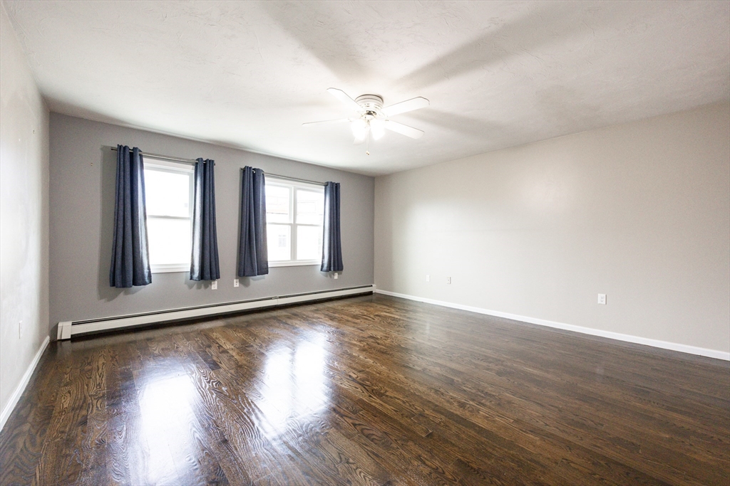 210 West Sixth Street, Unit 210 Boston, MA 02127 - Photo 29 of 36 a view of an empty room with wooden floor and a window