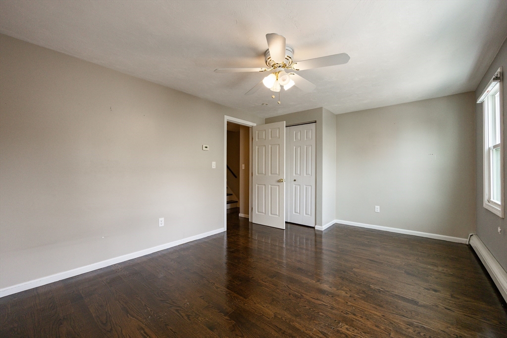 210 West Sixth Street, Unit 210 Boston, MA 02127 - Photo 30 of 36 a view of an empty room with wooden floor and a window