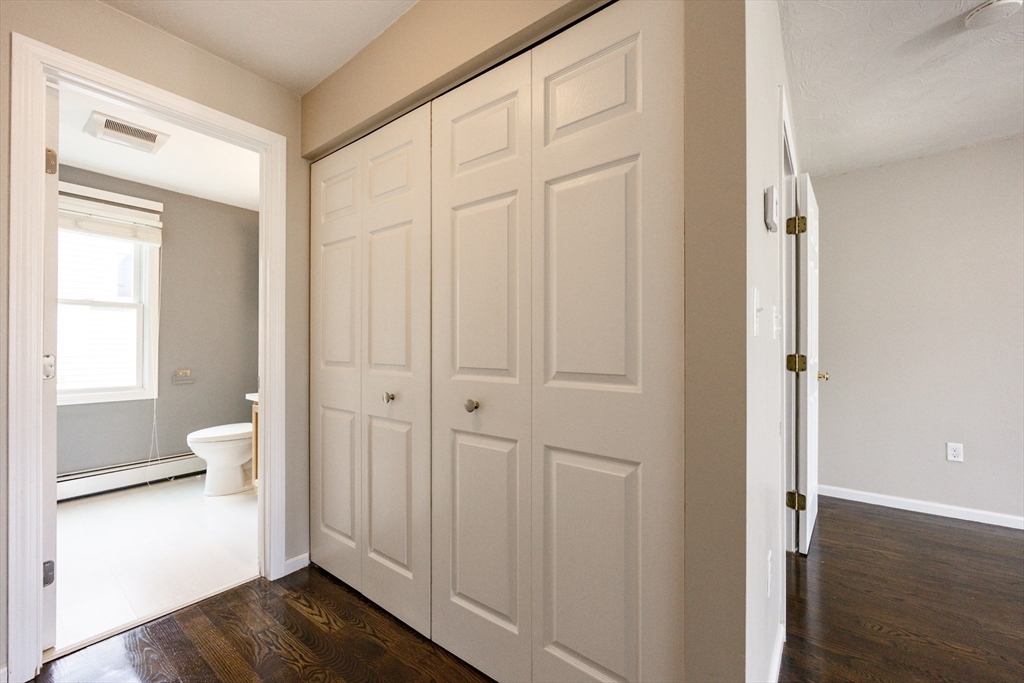 210 West Sixth Street, Unit 210 Boston, MA 02127 - Photo 32 of 36 a view of a bathroom with wooden floor mirror and windows
