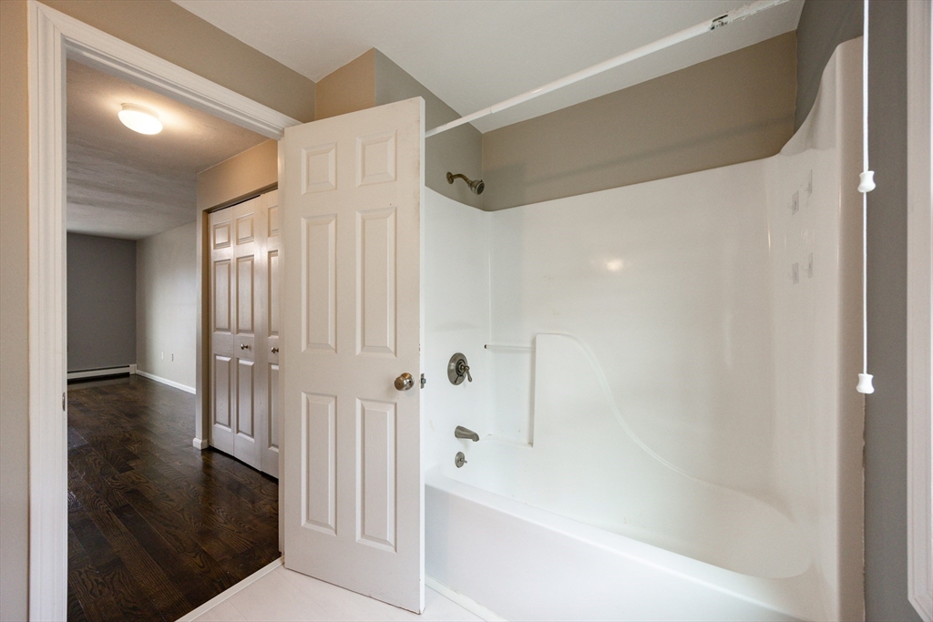 210 West Sixth Street, Unit 210 Boston, MA 02127 - Photo 34 of 36 a bathroom with a bathtub and a shower