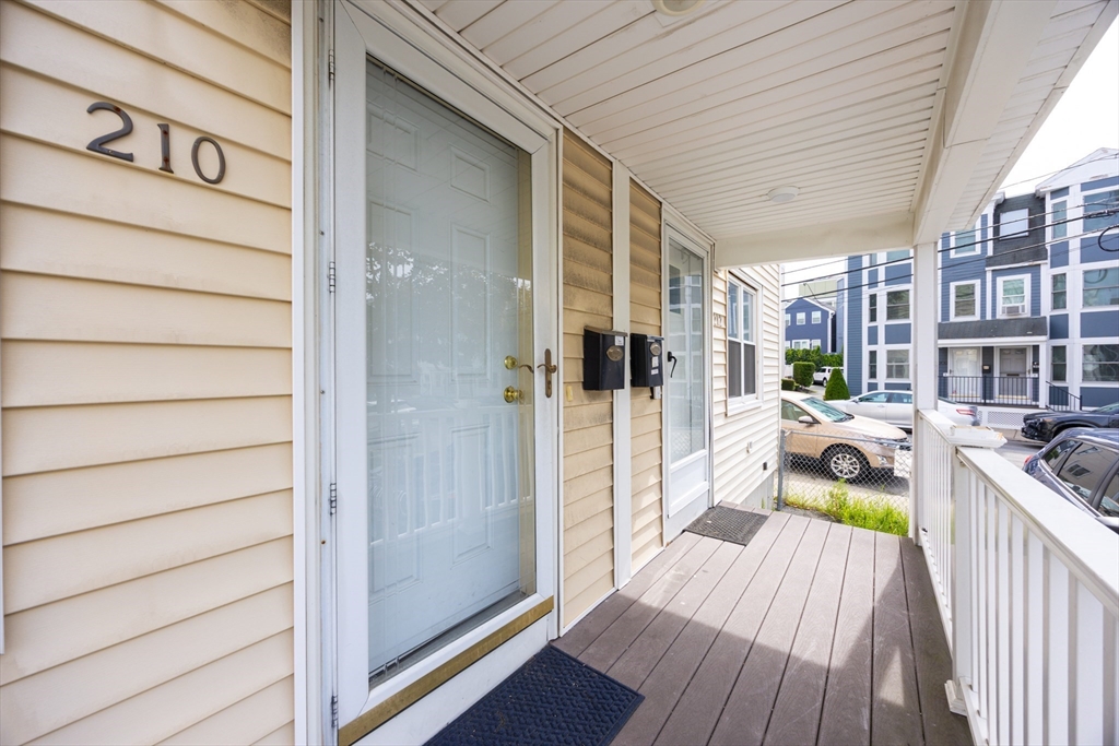 210 West Sixth Street, Unit 210 Boston, MA 02127 - Photo 4 of 36 a balcony with wooden floor and furniture