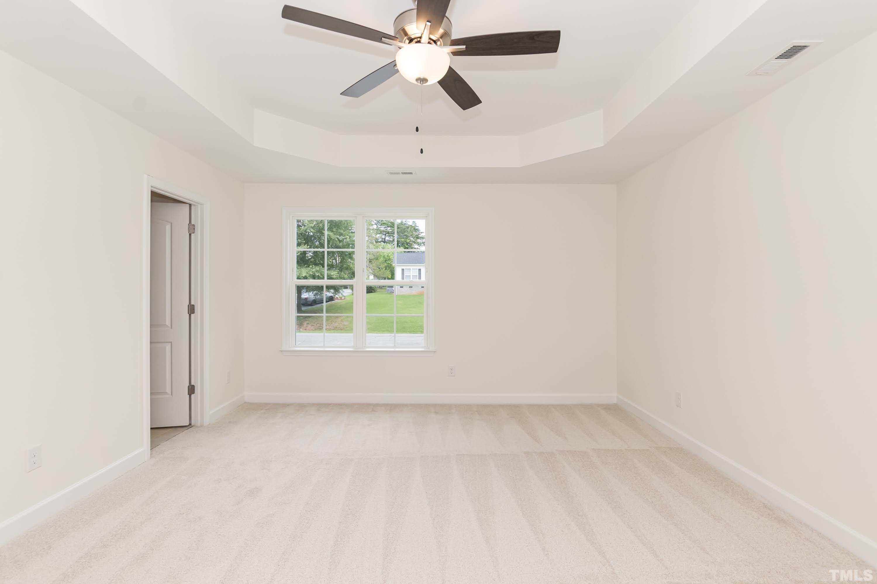 119 Carriage Loop Burlington, NC 27217 - Photo 16 of 29 an empty room with chandelier fan