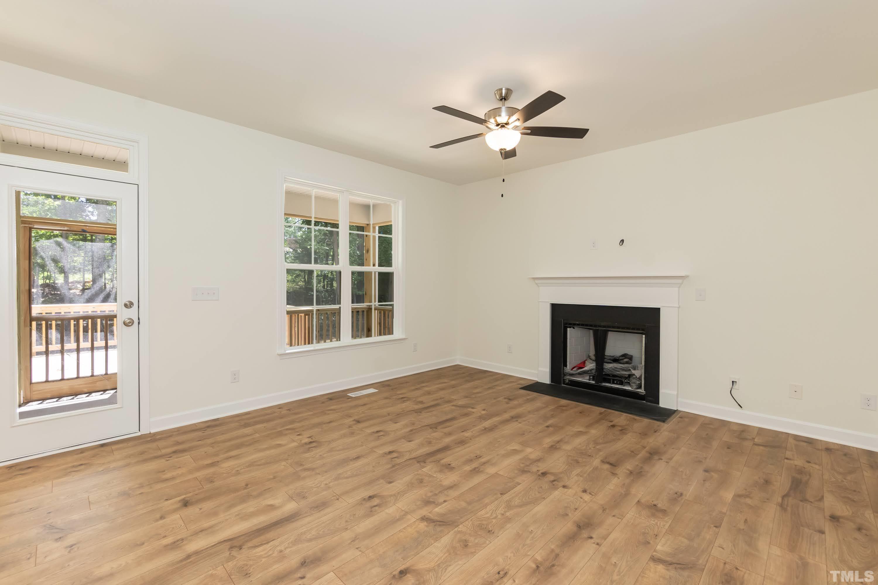 119 Carriage Loop Burlington, NC 27217 - Photo 6 of 29 a view of an empty room with a window and fireplace