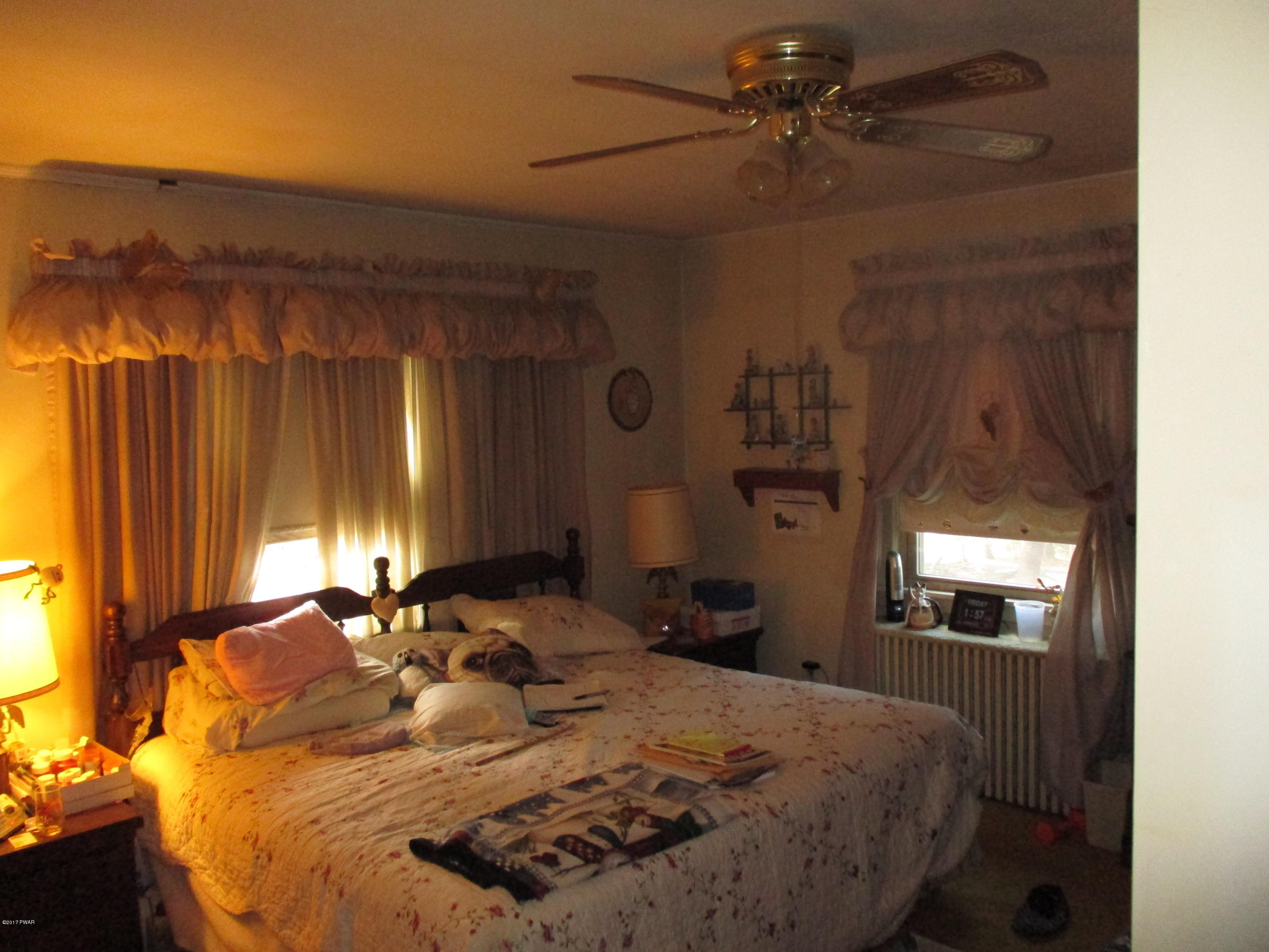 142 Log Tavern Road Milford, PA 18337 - Photo 12 of 24 a bedroom with a bed and a chandelier