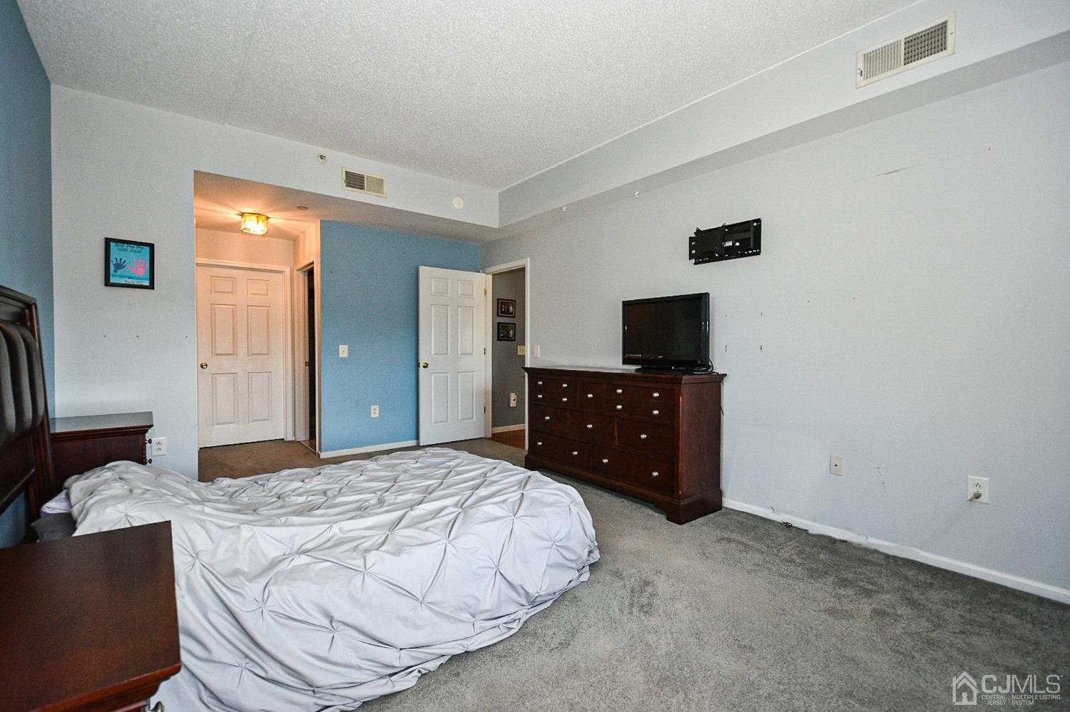 358 Rector Street, Unit 508 Perth Amboy, NJ 08861 - Photo 12 of 30 a bedroom with a bed and a television