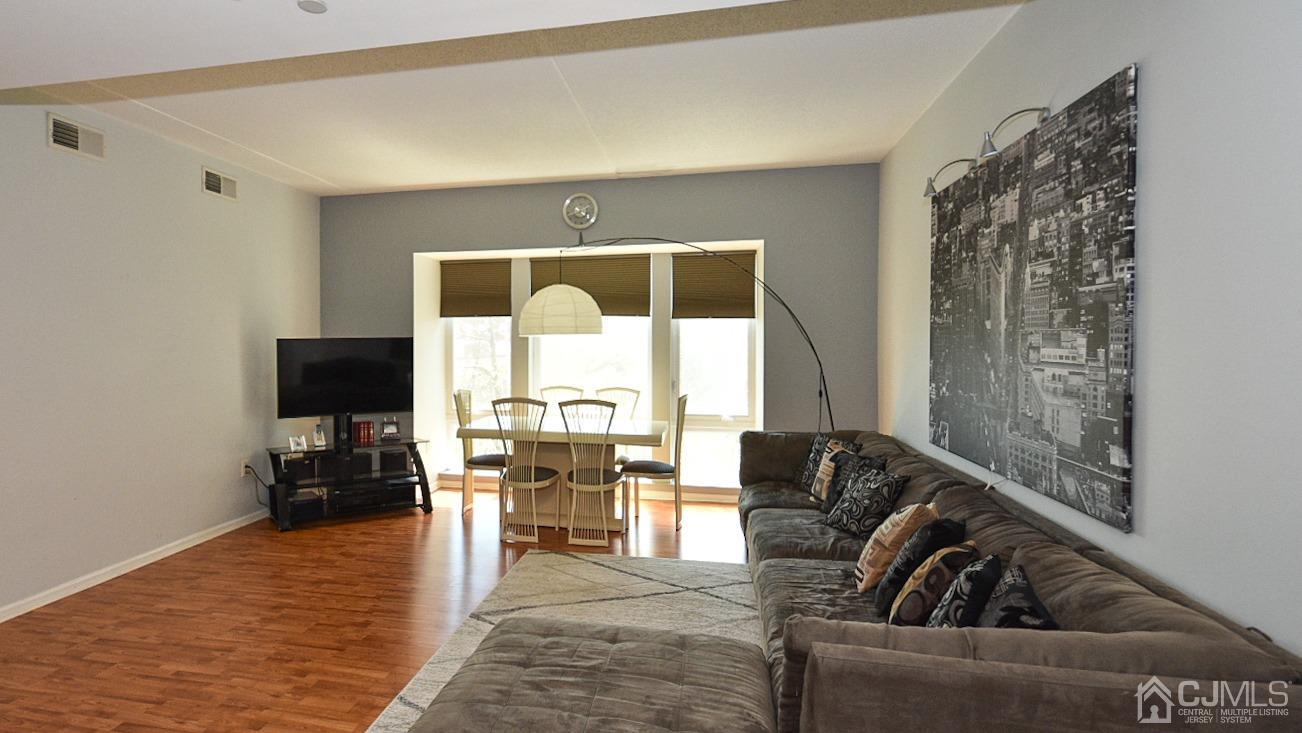 358 Rector Street, Unit 508 Perth Amboy, NJ 08861 - Photo 21 of 30 a living room with furniture and a flat screen tv with wooden floor