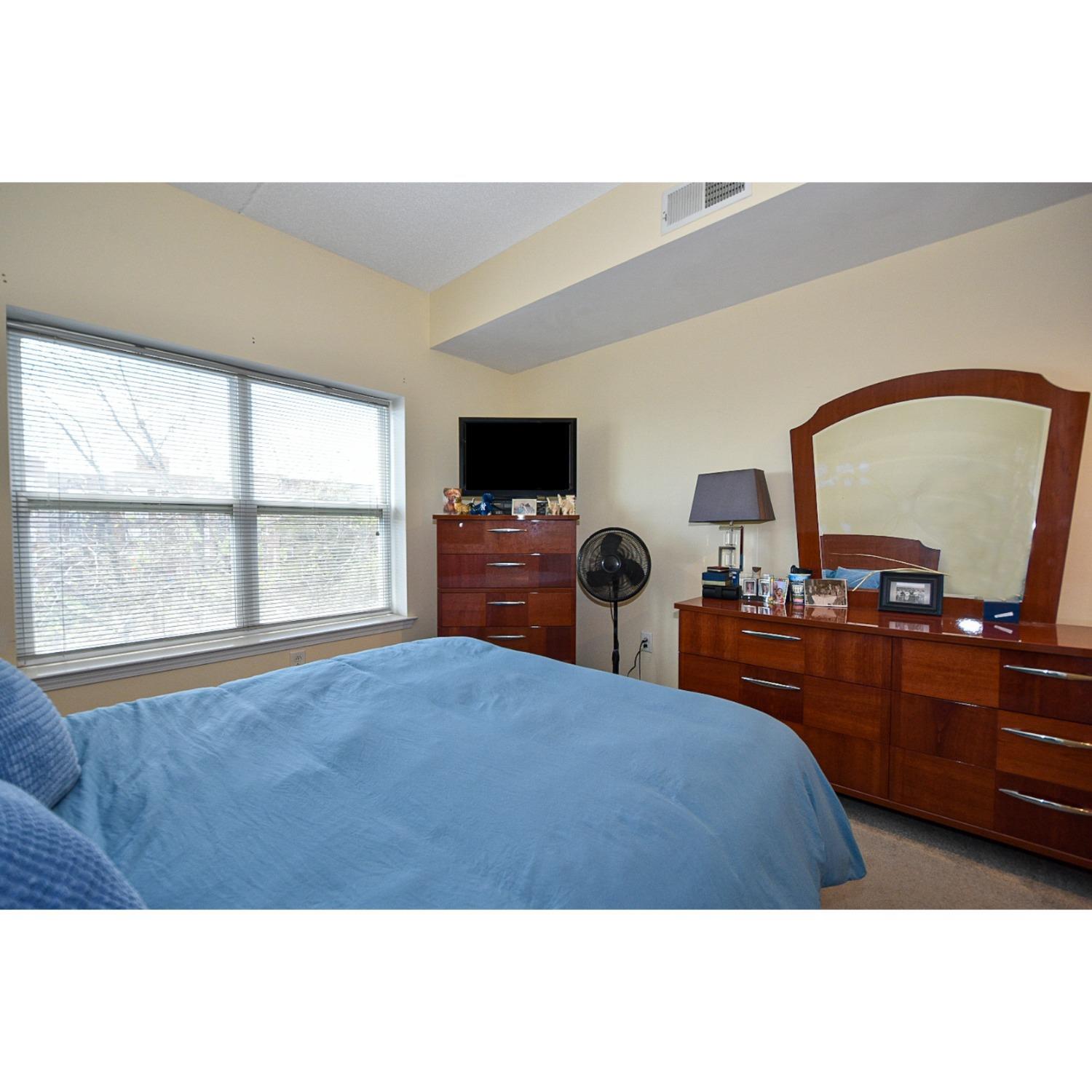 358 Rector Street, Unit 508 Perth Amboy, NJ 08861 - Photo 4 of 30 a bedroom with a bed and a flat screen tv