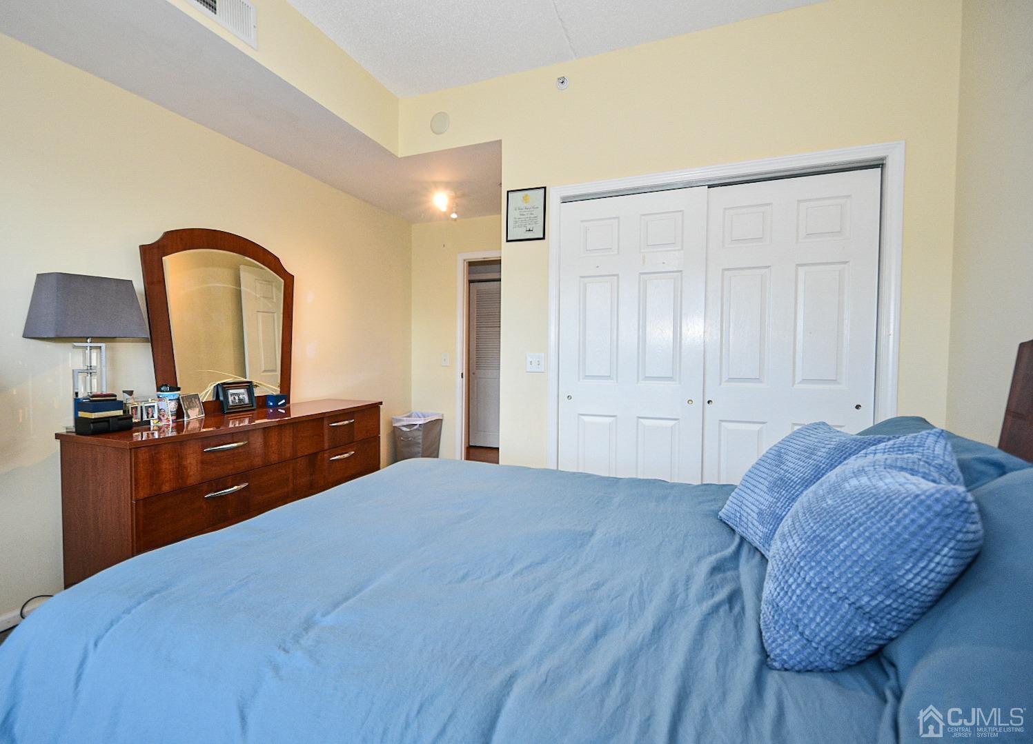 358 Rector Street, Unit 508 Perth Amboy, NJ 08861 - Photo 5 of 30 a bedroom with a bed and a dresser