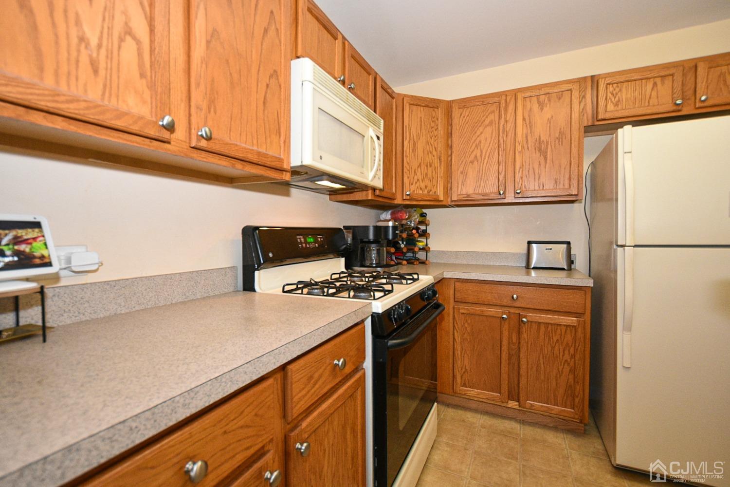 358 Rector Street, Unit 508 Perth Amboy, NJ 08861 - Photo 8 of 30 a kitchen with stainless steel appliances granite countertop a refrigerator a stove and a sink