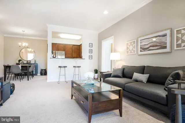 a living room with furniture and a dining area