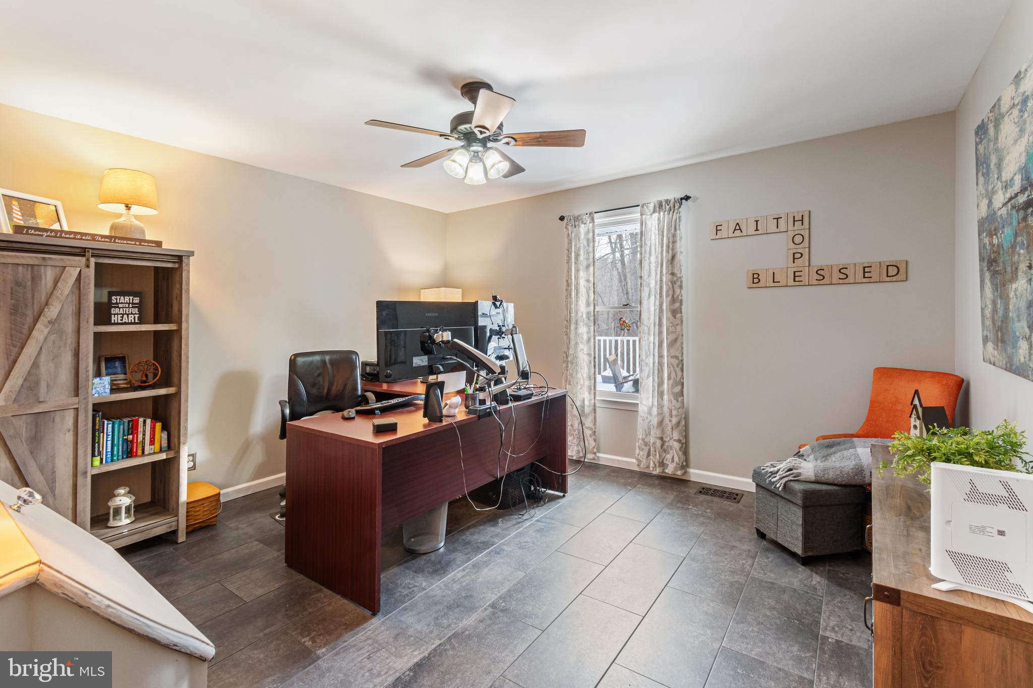 4507 Babylon Road Westminster, MD 21158 - Photo 17 of 63 a view of a workspace with furniture and a bookshelf