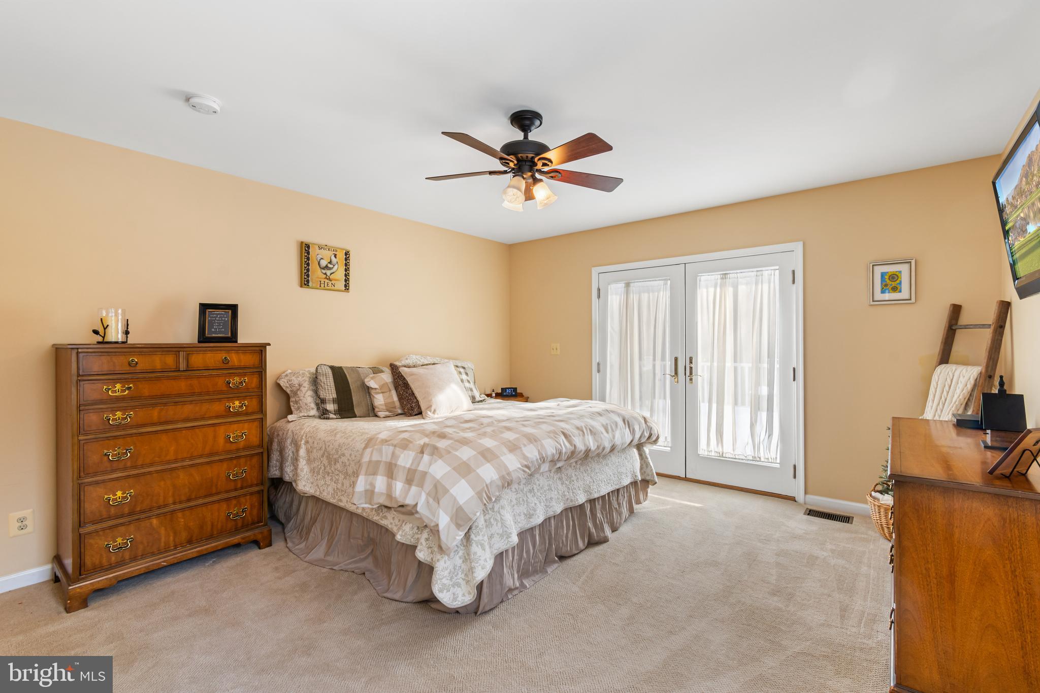 4507 Babylon Road Westminster, MD 21158 - Photo 20 of 63 a spacious bedroom with a bed and a flat screen tv