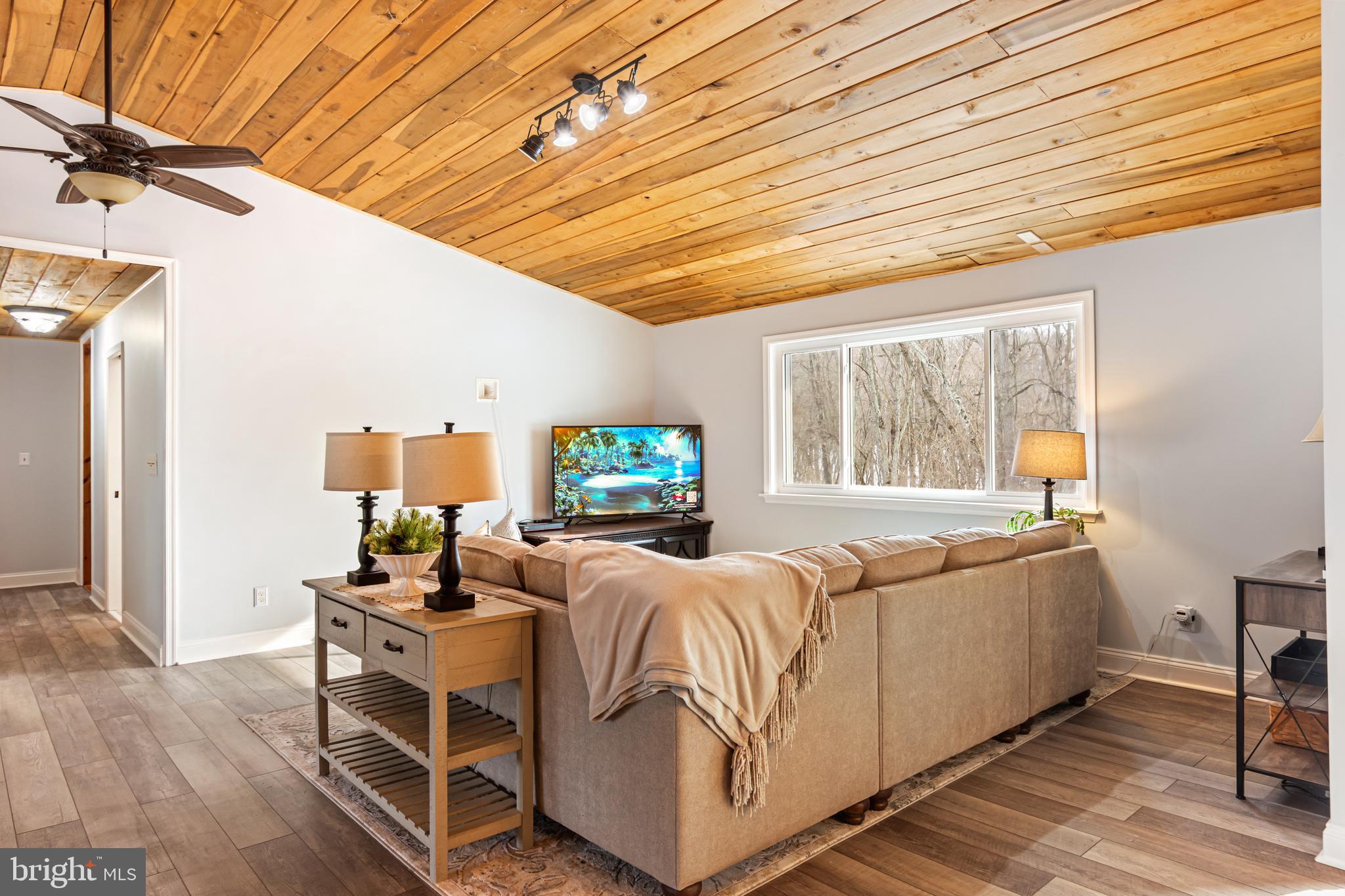 4507 Babylon Road Westminster, MD 21158 - Photo 24 of 63 a living room with furniture a flat screen tv and a large window