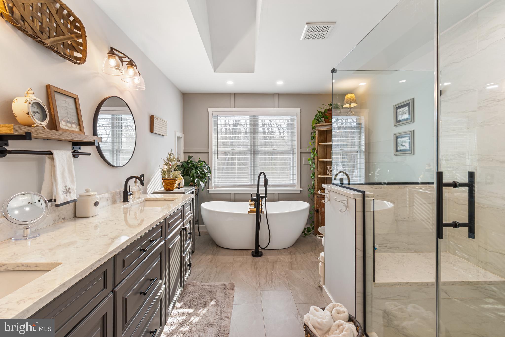 4507 Babylon Road Westminster, MD 21158 - Photo 26 of 63 a spacious bathroom with a double vanity sink a mirror and a bathtub