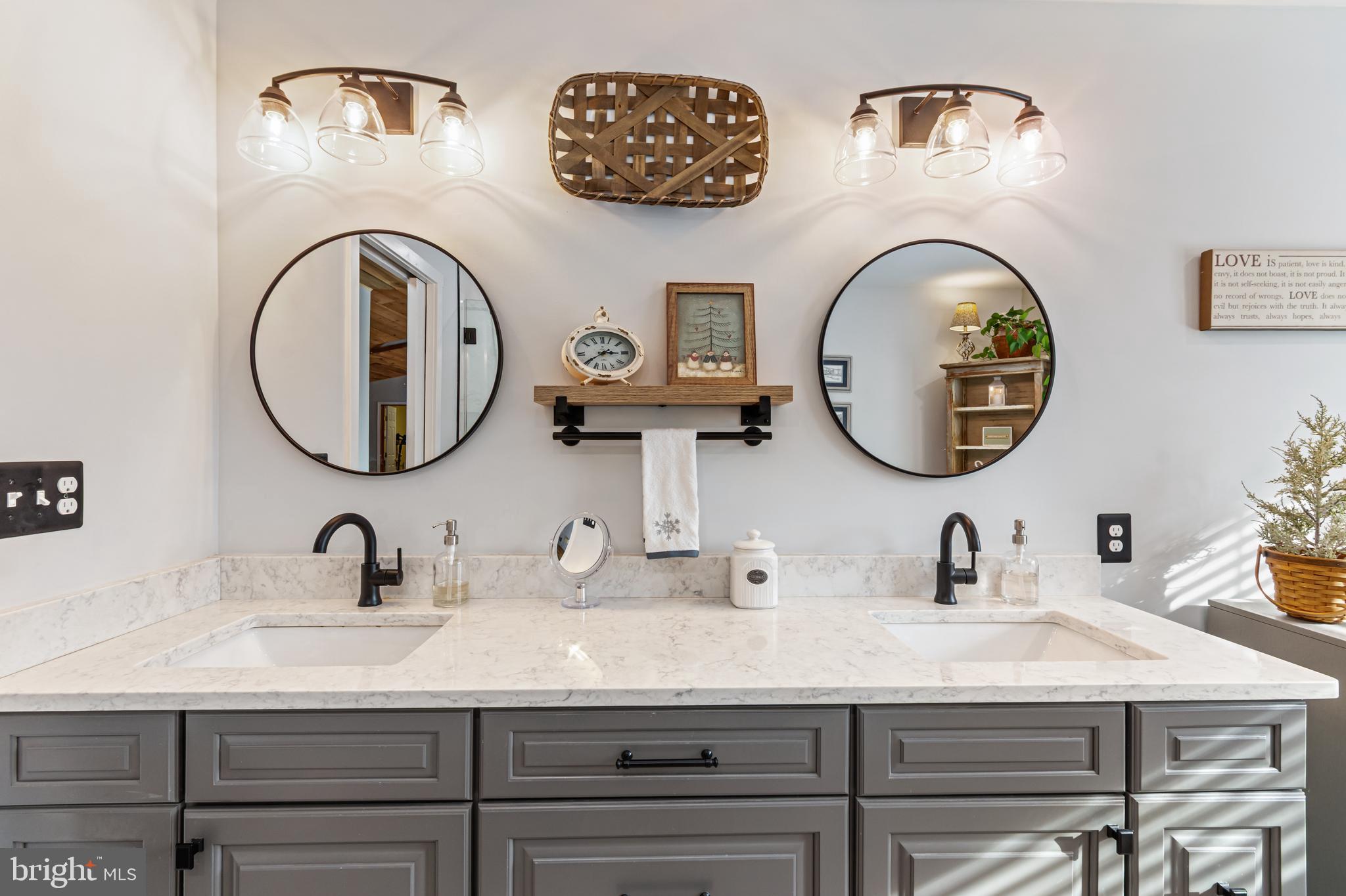 4507 Babylon Road Westminster, MD 21158 - Photo 27 of 63 a bathroom with double vanity sinks and a mirror