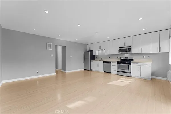 a view of kitchen with stainless steel appliances refrigerator oven and microwave