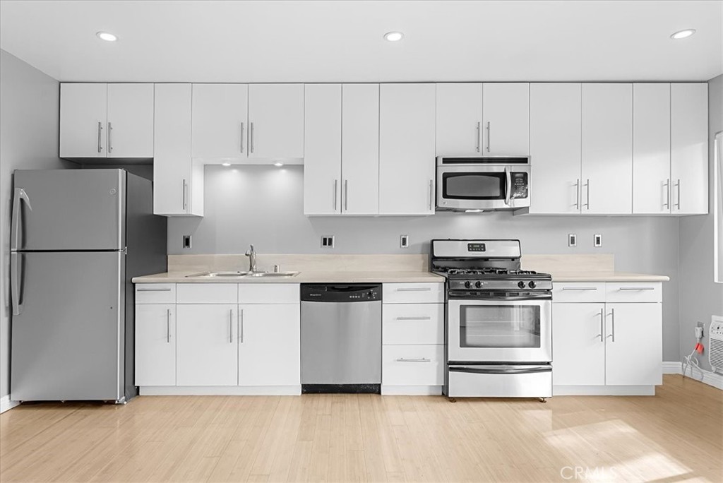 1527 Princeton Street, Unit 2 Santa Monica, CA 90404 - Photo 3 of 11 a kitchen with granite countertop white cabinets and stainless steel appliances
