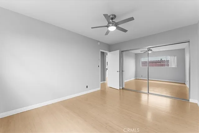 a view of an empty room with a chandelier fan