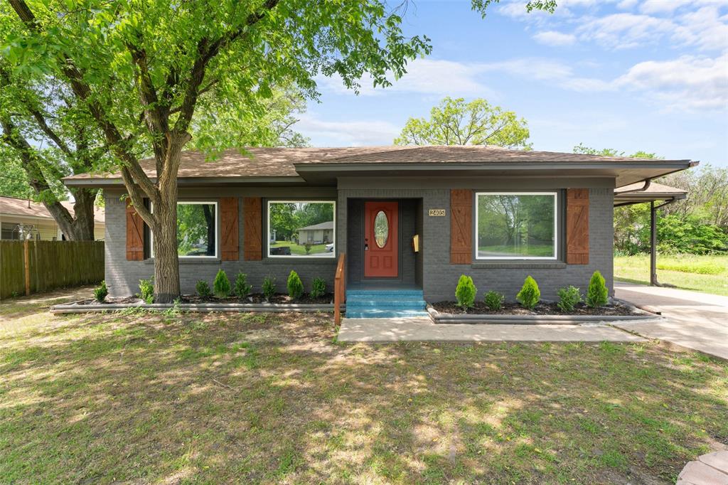 2405 Monroe Street Commerce, TX 75428 - Photo 3 of 31 a front view of a house with a yard